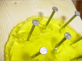 Close-up of jelly with nine nails in it